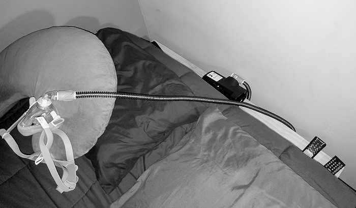 CPAP shelp with hose extending to where my head would be when sleeping