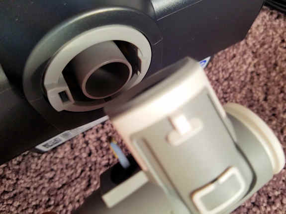Attaching the CPAP hose nozzle to the back of the CPAP machine